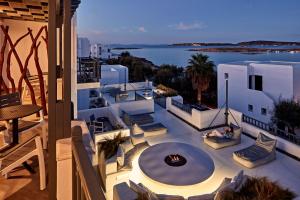 a balcony with a fire pit and a view of the water at Parian Boutique Hotel in Naousa