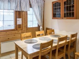 a dining room with a wooden table and chairs at Holiday Home Levimaa by Interhome in Sirkka