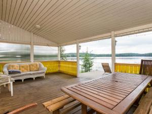 a screened in porch with a couch and a table at Holiday Home Joutsen by Interhome in Verla