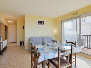 a kitchen and dining room with a table and chairs at Apartment Cabourg Beach by Interhome in Cabourg