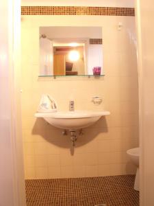 bagno con lavandino e specchio di Hotel La Capinera a Bellaria-Igea Marina