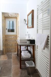 a bathroom with a sink and a mirror at Les Chambres du Prieuré in Pézenas
