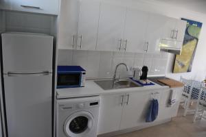 a kitchen with a refrigerator and a washing machine at MASPALOMAS - Area Ciudad in Playa del Ingles