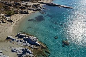 an aerial view of a beach with blue water at Parian Boutique Hotel in Naousa