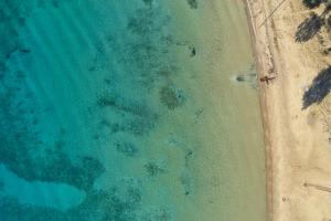 an overhead view of a beach and the ocean at Parian Boutique Hotel in Naousa
