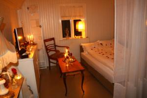 a small bedroom with a bed and a table with candles at Dalvík Vegamót Cottages in Dalvík