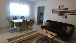 a living room with a table and a couch at Ferienwohnung Andreas in Herbolzheim