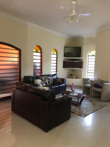 casa em Martins de Sá في كاراغواتاتوبا: غرفة معيشة مع أريكة وتلفزيون