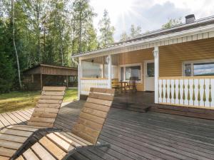 a deck with chairs on a house at Holiday Home Joutsen by Interhome in Verla