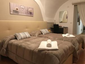 A bed or beds in a room at AFFITTACAMERE Il Cortile
