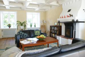 a living room with a couch and a table at Svanebäcks gård in Viken