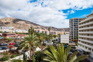 a view of a city with palm trees and buildings at Guayero in Los Cristianos