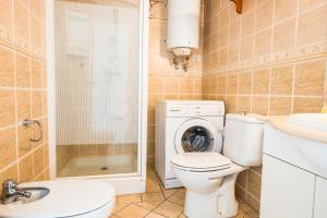 a bathroom with a toilet and a sink and a washing machine at Guayero in Los Cristianos +37 photos