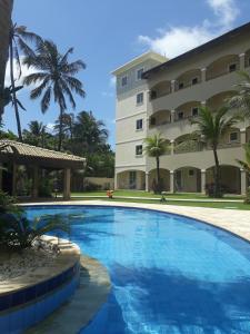 a swimming pool in front of a building at Cumbuco Paradise Beach Apartment in Cumbuco