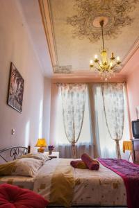 a bedroom with two beds and a chandelier at Vintage Apartment 2 rooms with Balcony in Lviv