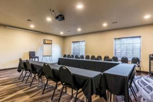 a conference room with tables and chairs and a whiteboard at Cobblestone Hotel & Suites - Torrington in Torrington