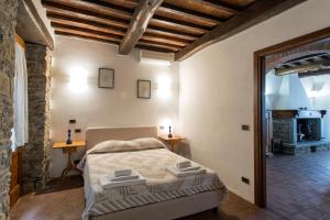 a bedroom with a bed and a fireplace at Villa Del Sole in Cortona +51 photos