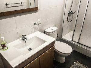 a bathroom with a sink and a toilet and a shower at Canos Verdes Apartment II in Angra do Heroísmo