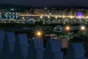 a view of a city at night with lights at Riad Dar Saba - Saba's House in Tangier