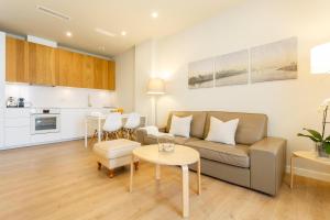 a living room with a couch and a table at Lujo Junto a la Catedral in Cádiz