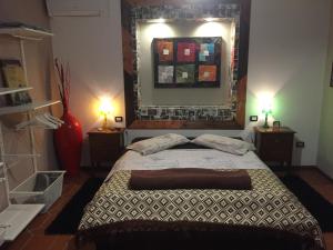 a bedroom with a bed and two lamps and a mirror at B&B Filomena in Santa Giusta +93 photos