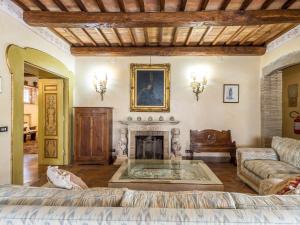 a living room with a couch and a fireplace at Villa Vista da Rocca di Papa-2 by Interhome in Rocca di Papa