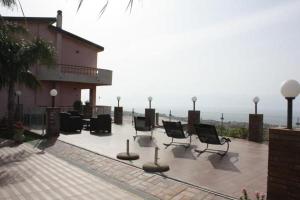 a group of chairs sitting on a patio near a building at B&B Angolo Di Paradiso in Pellaro