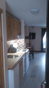 a kitchen with a sink and a counter top at Bernache in Mont-Tremblant +3 photos