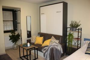 a living room with a brown couch and a table at Casa Do Medio in Santiago de Compostela