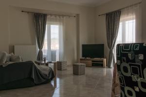 a living room with a television and a couch at Areti Apartment in Souda