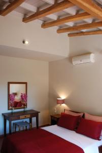 een slaapkamer met een bed en een tafel met een spiegel bij VILLA ISMINI, Skiathos in Skiathos-stad