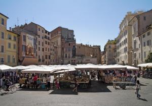 un marché dans une ville avec des parapluies blancs dans l'établissement Farnese House in Rome, à Rome
