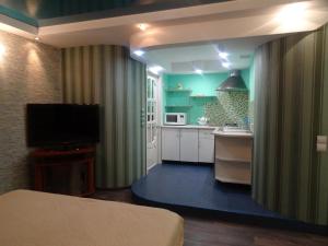 a room with a kitchen with a bed and a television at Apart in Kropyvnytskyi
