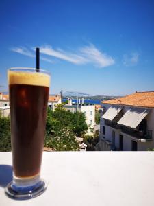 a glass of coffee sitting on a table with a view at Spetses Center Comfy Apartment in Spetses