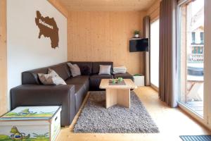 a living room with a couch and a coffee table at Hirsch Chalet in Sankt Lorenzen ob Murau