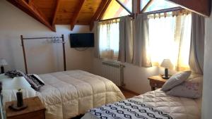 מיטה או מיטות בחדר ב-Paso Puyehue