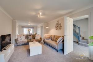 a living room with a couch and a table at The Buddha House Huntingdon Boutique Rooms in Godmanchester