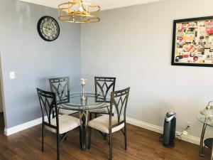 a dining room with a glass table and chairs at Amazing Spare Bedroom in Shared 2/B Condo behind Convention Center in Las Vegas