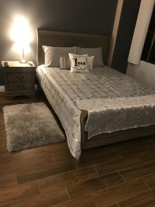 a bedroom with a bed and a night stand with a lamp at Amazing Spare Bedroom in Shared 2/B Condo behind Convention Center in Las Vegas