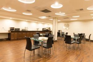 a conference room with tables and chairs and a counter at Mayfair Inn and Suites in Queens
