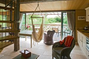 a kitchen and living room with a hammock at La Ferme de L'Oudon & SPA in Berville