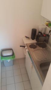 a small kitchen with a sink and a trash can at Appartement in Glinde in Glinde