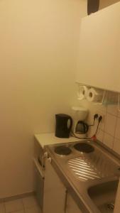 a small kitchen with a stove and a sink at Appartement in Glinde in Glinde