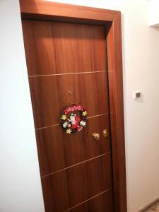 a wooden door with a wreath on it at Αnna's Home!!!Holidays in beautiful Athens in Athens