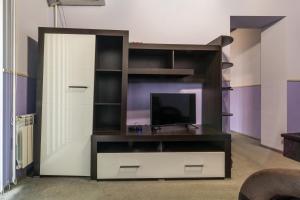 a entertainment center with a flat screen tv in a room at Apartments for your happiness in Dnipro +2 photos