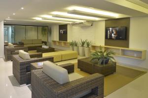 a living room with couches and chairs and a television at Tabatinga Residence Service - Flat 02 in Conde