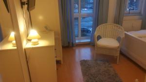 a room with a chair and a table with a lamp at Appartement in Glinde in Glinde