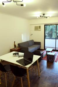 a living room with a table with a laptop on it at "Tu Lugar en el Norte" Dpto SADIMA - Barrio Norte in San Miguel de Tucumán