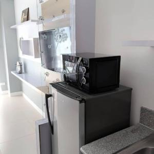 un four micro-ondes installé au-dessus d'un comptoir avec une chaise dans l'établissement The Penn Room Tagaytay at Cool Suites, à Tagaytay