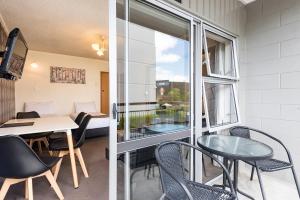 a room with a table and chairs and a window at Heartland Ambassador Hotel Hamilton in Hamilton
